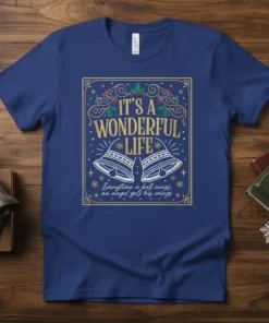 It's a Wonderful Life quote with bells and angel wings graphic on a blue t-shirt
