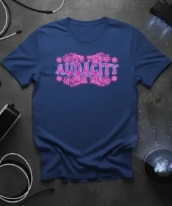 IT'S THE AUDACITY FOR ME text in bold pink neon font with floral accents on a navy t-shirt