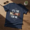 Text "IT'S THE MELANIN FOR ME" in bold white and brown letters on a dark navy t-shirt, celebrating melanin pride