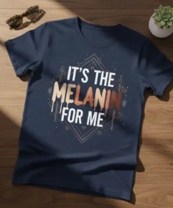Text "IT'S THE MELANIN FOR ME" in bold white and brown letters on a dark navy t-shirt, celebrating melanin pride