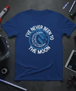 I've Never Been To The Moon quote with geometric moon graphic on a blue t-shirt