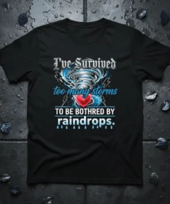 I've Survived too many storms TO BE BOTHRED BY raindrops. quote on a black t-shirt with a tornado and heart