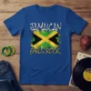 Royal blue t-shirt with "JAMAICAN GIRLS ROCK" text above a distressed Jamaican flag design, symbolizing pride and heritage