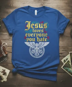 Blue T-Shirt with "Jesus loves everyone you hate" quote in gothic font and a cross with wings emblem