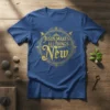 Gold ornate typography design on a blue t-shirt reads "Jesus Makes All Things New"