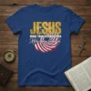 Jesus More Than A Conqueror quote on a blue t-shirt with American flag graphic and gold distressed font