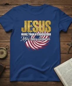 Jesus More Than A Conqueror quote on a blue t-shirt with American flag graphic and gold distressed font