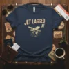 Navy t-shirt with "JET LAGGED AF" text and a vintage airplane graphic circling the globe