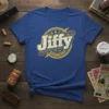 Jiffy Est. 1950 Instant Results logo t-shirt with distressed yellow and white text on a blue tee