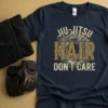 Jiu-Jitsu Hair Don't Care text design on a navy t-shirt, featuring distressed typography and a graphic of flowing hair