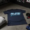 Jiu-Jitsu It's How I Roll text design on a navy blue t-shirt, featuring blue neon-style lines