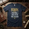 Navy blue t-shirt with gold text: "JOHN. THE MAN. THE MYTH. THE LEGEND." design, featuring gears and a griffin graphic