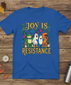 Joy is Resistance slogan t-shirt with a frog, chicken, shark, and dinosaur characters, surrounded by flowers and confetti