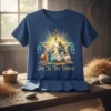 Nativity scene with Mary, Joseph, and baby Jesus, featuring the text "Joy To The World" on a blue t-shirt