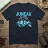 Juneau Alaska Whale Tail Mountains T-Shirt design featuring blue text and a stylized whale tail above mountain peaks