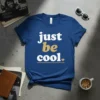 Blue t-shirt with white and gold text that reads "just be cool." featuring a small heart and line accent