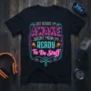Black t-shirt with neon-style text reading "JUST BECAUSE I'M AWAKE DOESN'T MEAN I'M READY To Do Stuff"