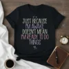 Black t-shirt with colorful text that reads "JUST BECAUSE I'M AWAKE DOESN'T MEAN I'M READY TO DO THINGS"