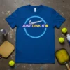 Blue t-shirt with "JUST DINK IT" text and a pickleball graphic, featuring a neon circle design