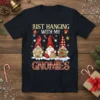 Christmas t-shirt with the text "JUST HANGING WITH MY GNOMIES" and three cute gnomes in festive hats and outfits