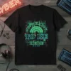 Cyberpunk t-shirt with neon green text "JUST HAPPY TO BE HERE" and Japanese characters, set against a digital city backdrop