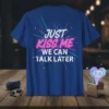 Just Kiss Me We Can Talk Later text design on a blue t-shirt with neon-style graphic accents