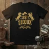 Black t-shirt with gold "JUST LEDOUX IT" text, cowboy hat, lasso, bucking horse, and crossed pistols graphic
