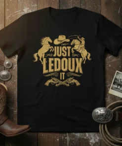Black t-shirt with gold "JUST LEDOUX IT" text, cowboy hat, lasso, bucking horse, and crossed pistols graphic