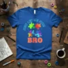 Blue t-shirt with colorful puzzle pieces and the text "Just Let Me Stim Bro" in bold orange font