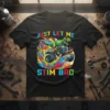 Just Let Me Stim Bro t-shirt with a green T-Rex dinosaur riding a colorful monster truck, featuring autism puzzle piece
