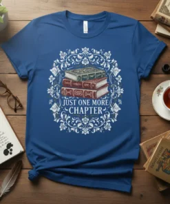 Just One More Chapter quote on a blue t-shirt with a stack of vintage books illustration surrounded by floral design