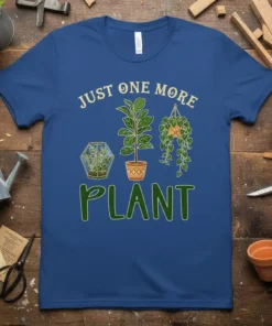 Blue t-shirt with "JUST ONE MORE PLANT" text and illustrations of a terrarium, potted plant, and hanging plant
