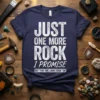 T-shirt with white distressed text reading "JUST ONE MORE ROCK I PROMISE BUT THAT ONE LOOKS GOOD TOO" on a