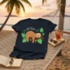Dark navy t-shirt with "JUST RELAX" text and a cute brown sloth hanging on a branch surrounded by green leaves