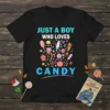 Black t-shirt with "JUST A BOY WHO LOVES CANDY" text and a colorful assortment of candies, cupcakes, and ice cream