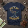 Just A Boy Who Loves Dinosaurs text design with T-Rex skeleton graphic on a navy blue t-shirt