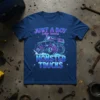 JUST A BOY who loves MONSTER TRUCKS text with a graphic of a monster truck on a navy blue t-shirt