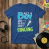 Blue t-shirt with "JUST A BOY WHO REALLY LOVES SINGING" text and a vintage microphone graphic