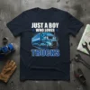 Just A Boy Who Loves Trucks text with a blue semi-truck graphic on a navy t-shirt design