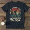 Retro Bigfoot graphic t-shirt with text "JUST A DAD WHO ALWAYS CAME BACK WITH THE The Milk" and sunset background