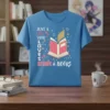 Just A Girl Who Loves Anime & Books quote with open book graphic and stars on a blue t-shirt