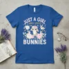 Just A Girl Who Loves Bunnies text with cute bunnies and floral design on a blue t-shirt