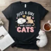 Just A Girl Who Loves Cats text with two cute cats, one sleeping and one playing with yarn, on a