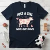 Just a girl who loves cows text with a floral cow graphic on a navy t-shirt