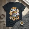 Just A Girl Who Loves Dogs quote with multiple cartoon dogs on a dark t-shirt design