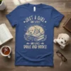 Just a Girl Who Loves Dogs and Books t-shirt featuring a sleeping puppy on a stack of books, with vintage-style