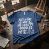 Just A Girl Who Loves Doodles text with cute doodle dog illustrations on a navy blue t-shirt
