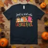 Just a girl who LOVES FALL text with pumpkin, coffee mug, and boots graphic on a navy t-shirt