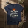 Just a girl who loves Foxes text with a fox face graphic on a navy blue t-shirt
