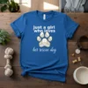 Blue t-shirt with white text "just a girl who loves her rescue dog" and a stylized paw print graphic
